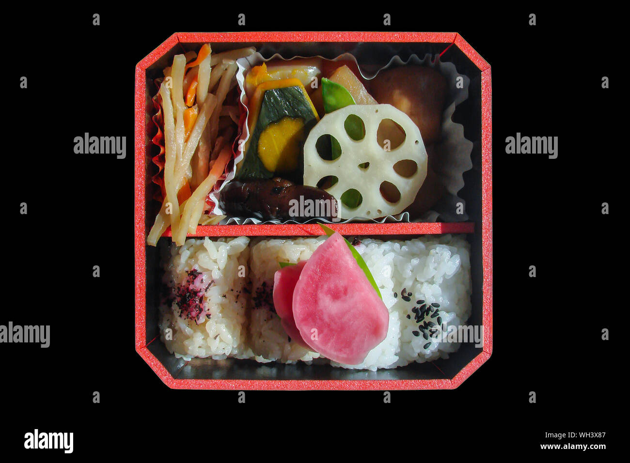 Top view of a square japanese bento box with rice and vegetables, isolated on black background Stock Photo