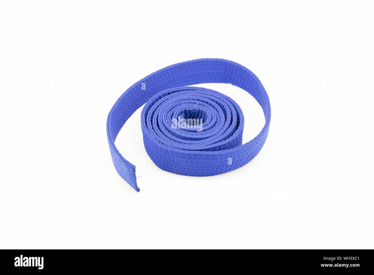 Blue karate belt on white background Stock Photo - Alamy