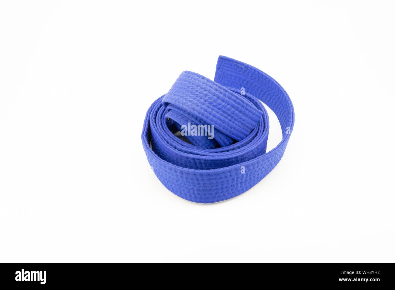 Blue karate belt on white background Stock Photo - Alamy