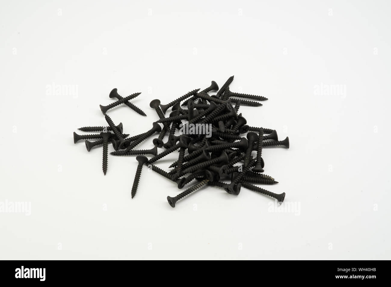 Screw black. Steel screw for a cross-head screwdriver. Wood carving Stock Photo