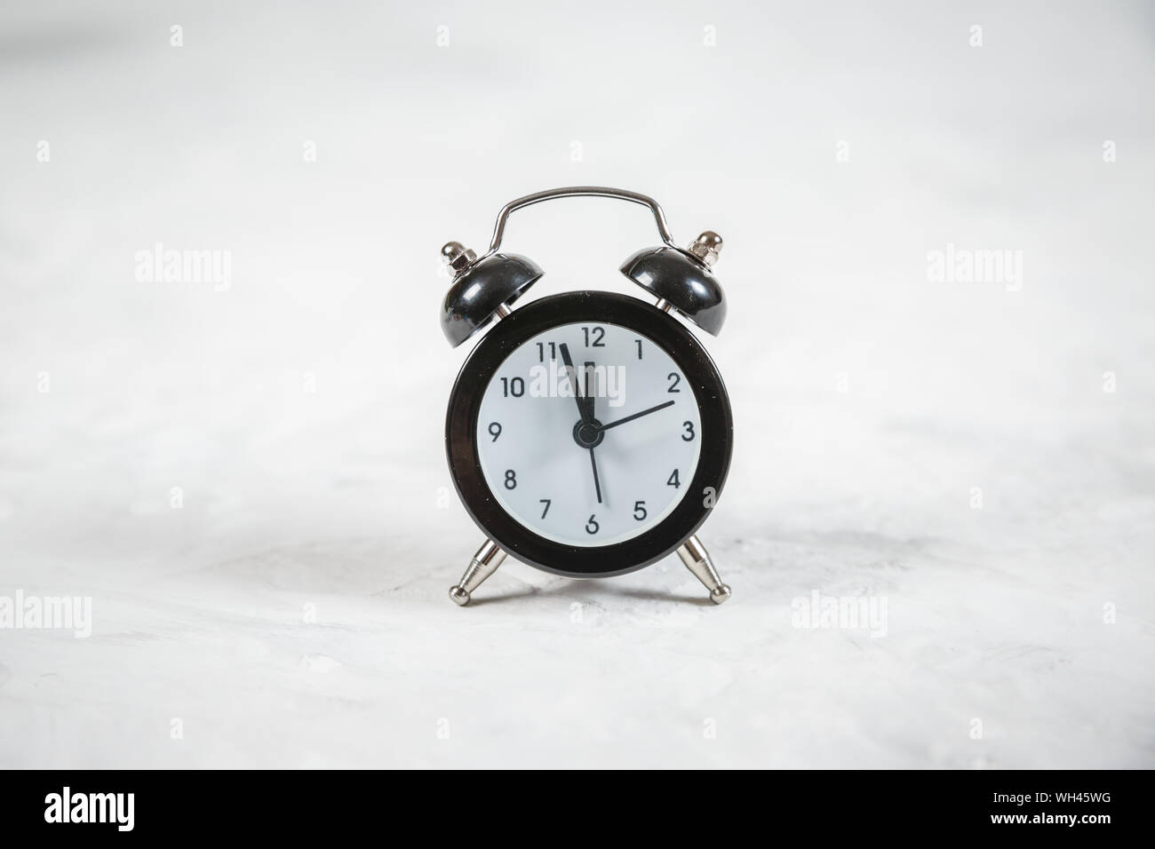 Retro alarm clock on white background Stock Photo - Alamy