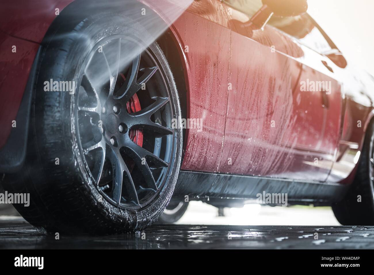 Muscle Car in a Car Wash. Automotive Industry. Vehicle Outside Cleaning