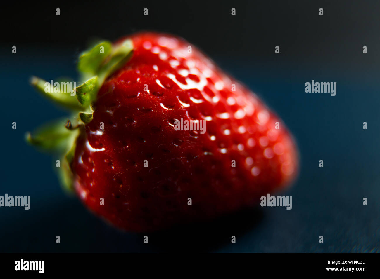 Fresh red strawberry isolated on a black background Stock Photo - Alamy