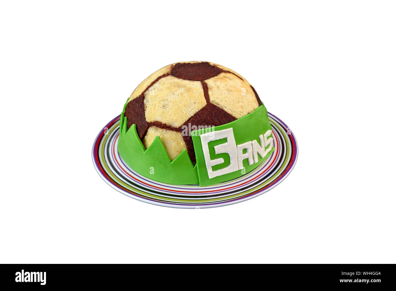 Beautiful soccer ball birthday cake for the fifth anniversary (5 years written in french '5 ans' on the cake), isolated on white background. Stock Photo