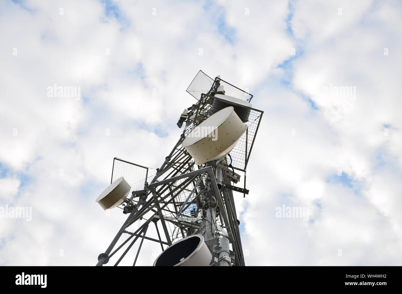 Low Angle View Of Global Communications Towers Against Sky Stock Photo