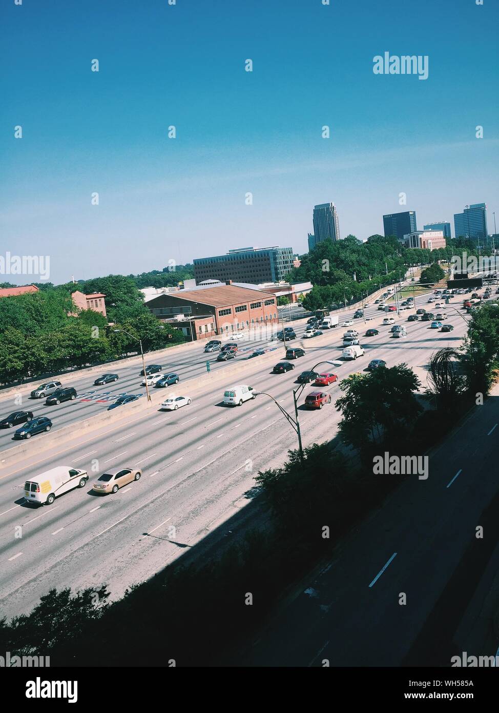 High Angle View Of Vehicles On Two Lane Highway During Sunny Day Stock Photo