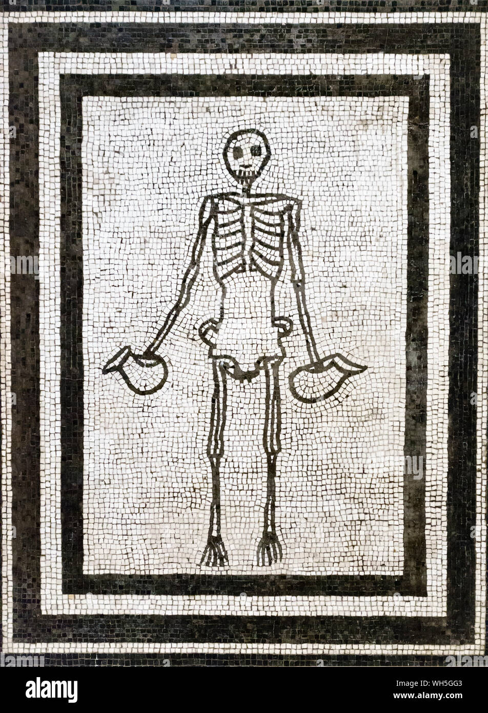 Pompeii, Italy. Floor mosaic of a skeleton holding wine jugs, now in the National Archaeological Museum of Naples (circa 1AD) Stock Photo