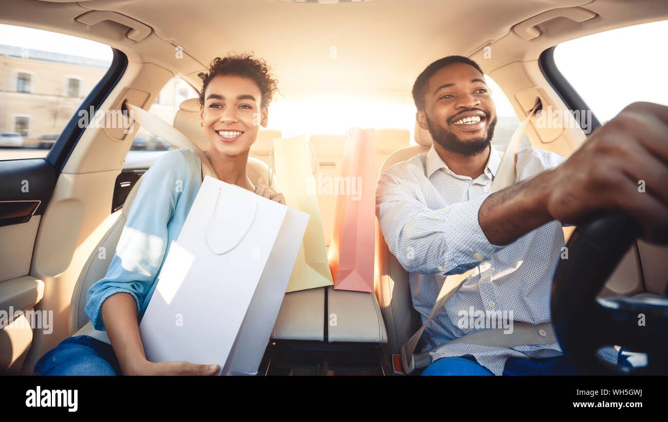 Afro couple driving home after shopping in mall Stock Photo