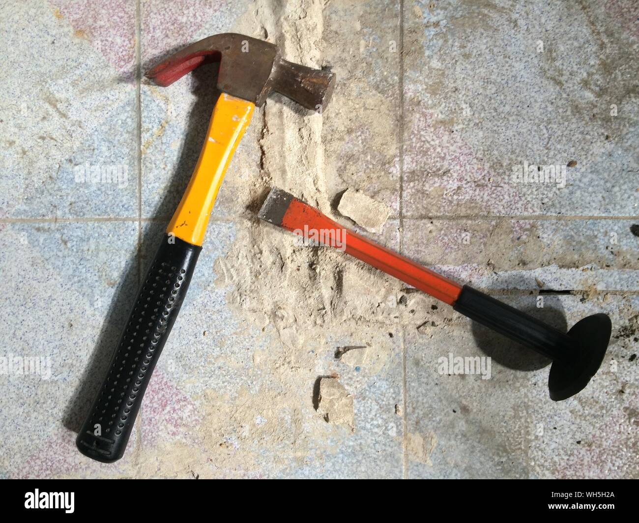 Hammer With Chisel On Tiled Floor Stock Photo