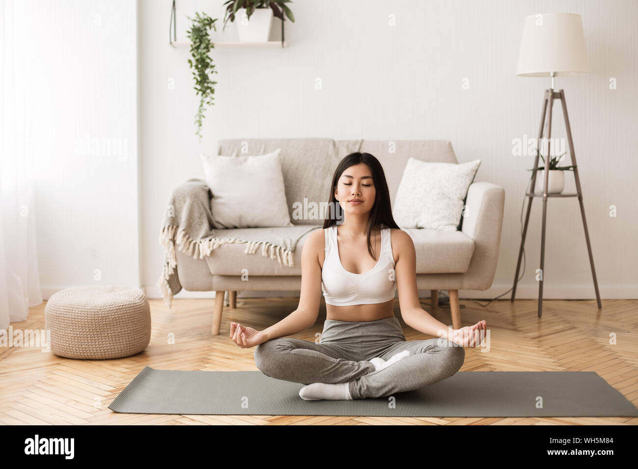 Morning Meditation. Asian Girl Practicing Yoga at Home Stock Photo - Alamy