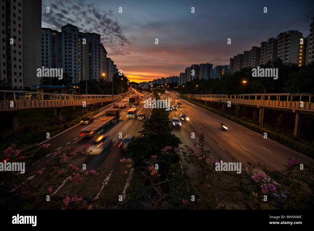 Night View Of City Buildings And Highway Against Sky Stock Photo