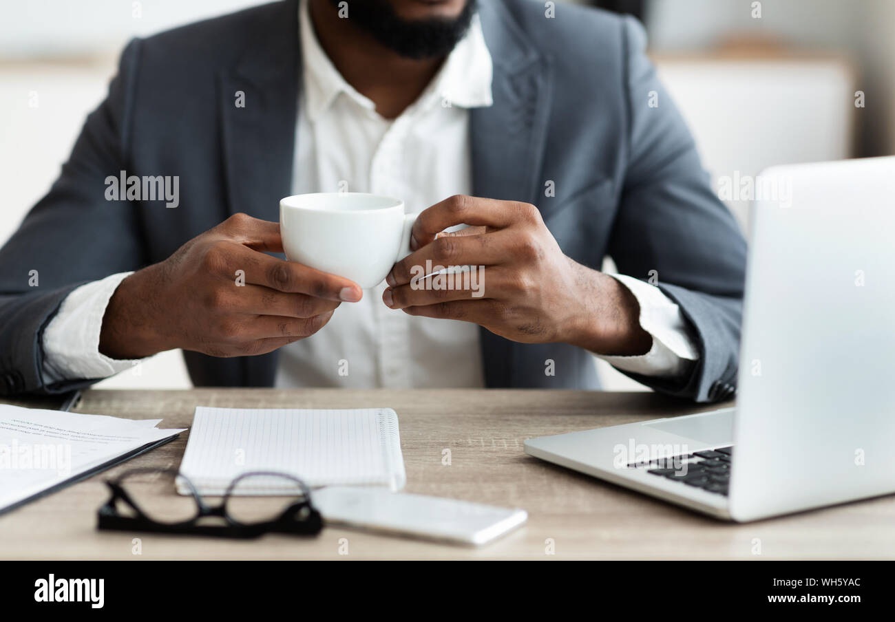 African american businessman drinking coffee at workplace Stock Photo