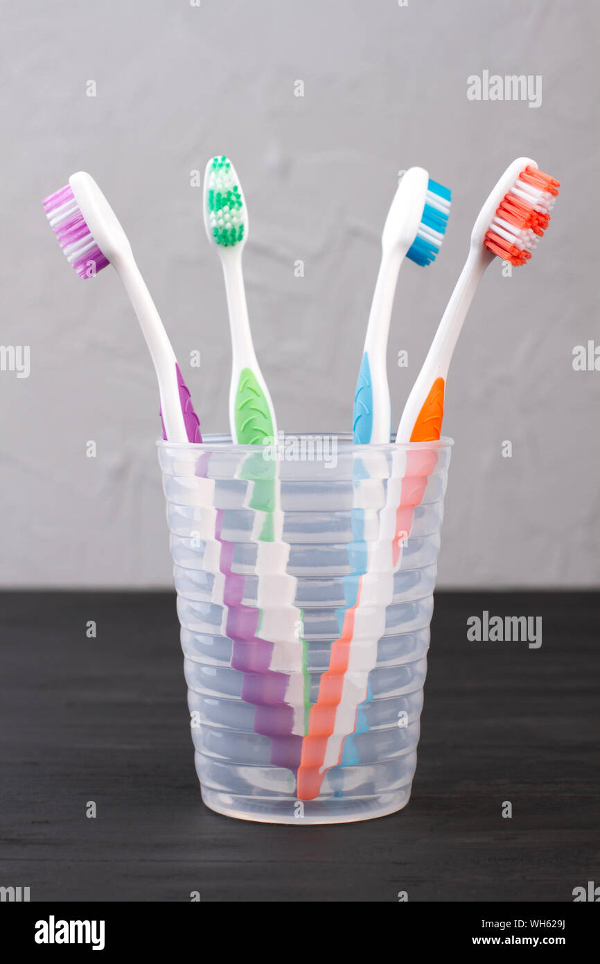 Set of toothbrushes in glass Stock Photo - Alamy