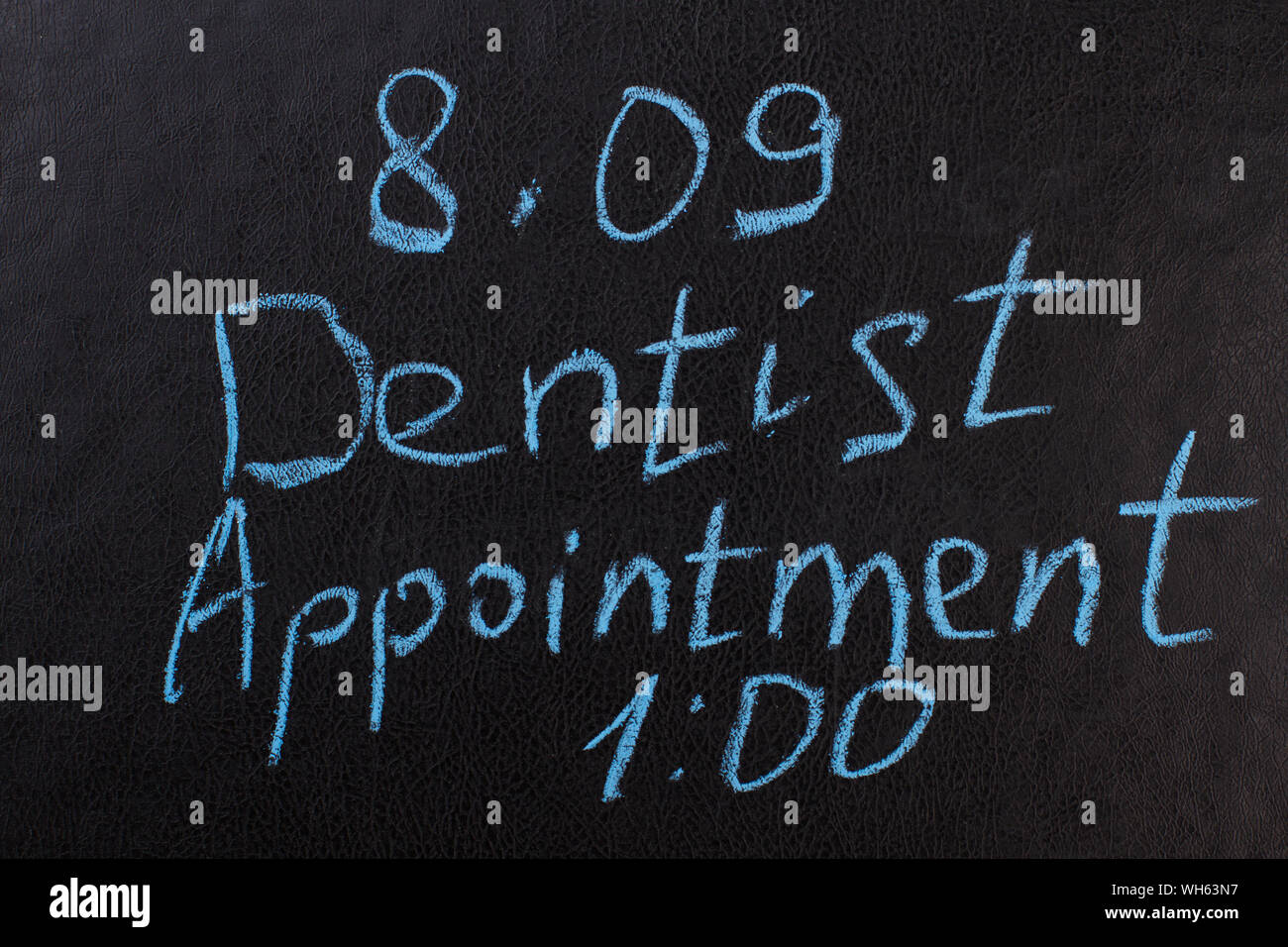 Dentist appointment reminder on chalkboard. Stock Photo