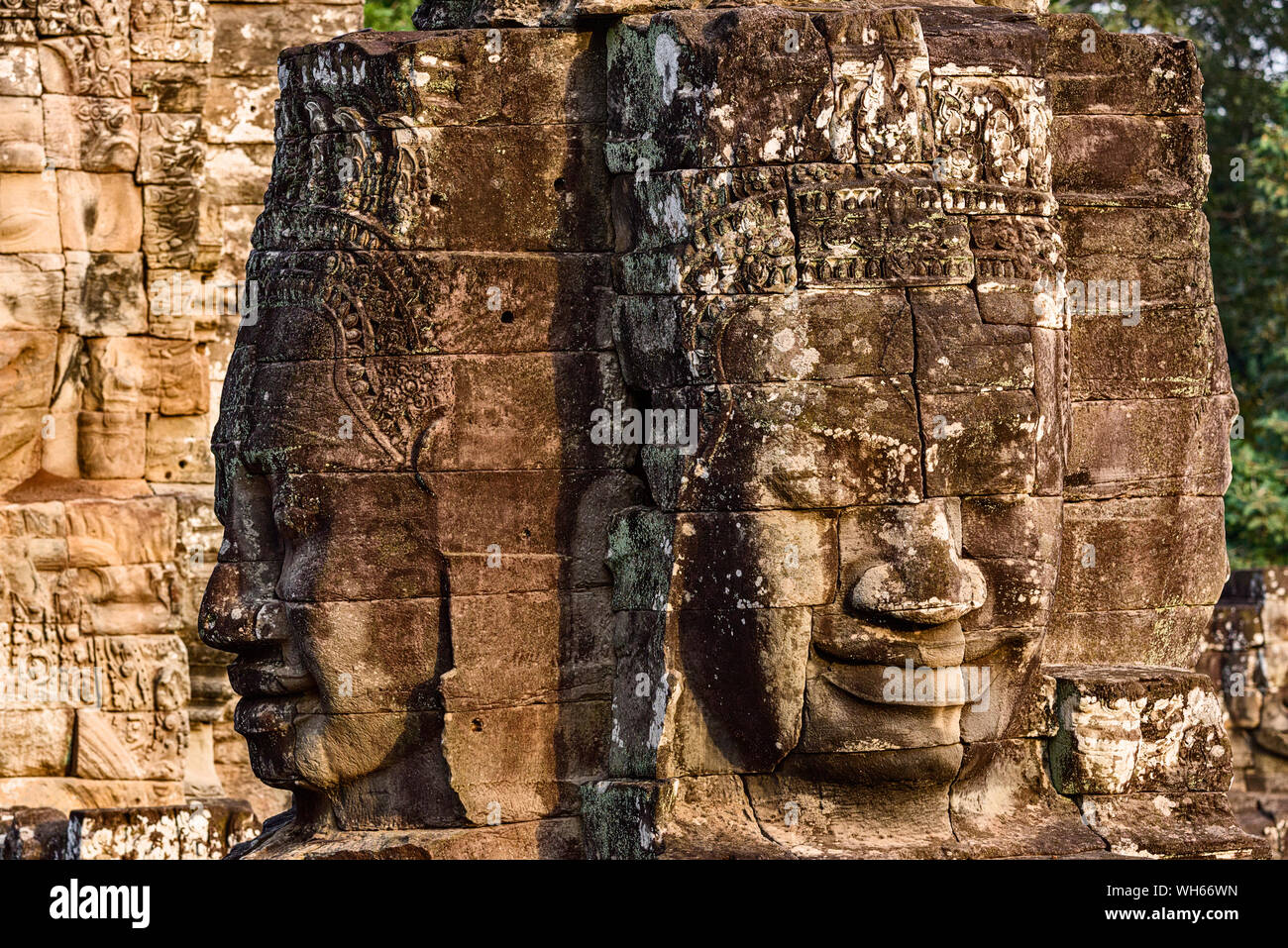 Enigmatic and smiling stone faces of the Buddha giants at the Bayon temple in Siem Reap, Cambodia Stock Photo