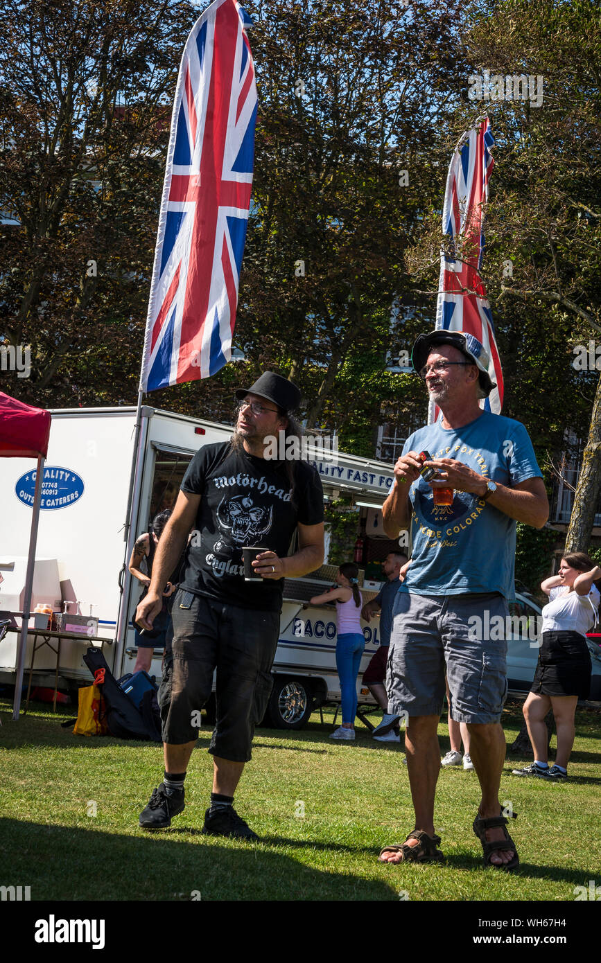 People listening to a band at the Steyne Gardens on August Bank Holiday, Worthing, West Sussex, England, UK Stock Photo