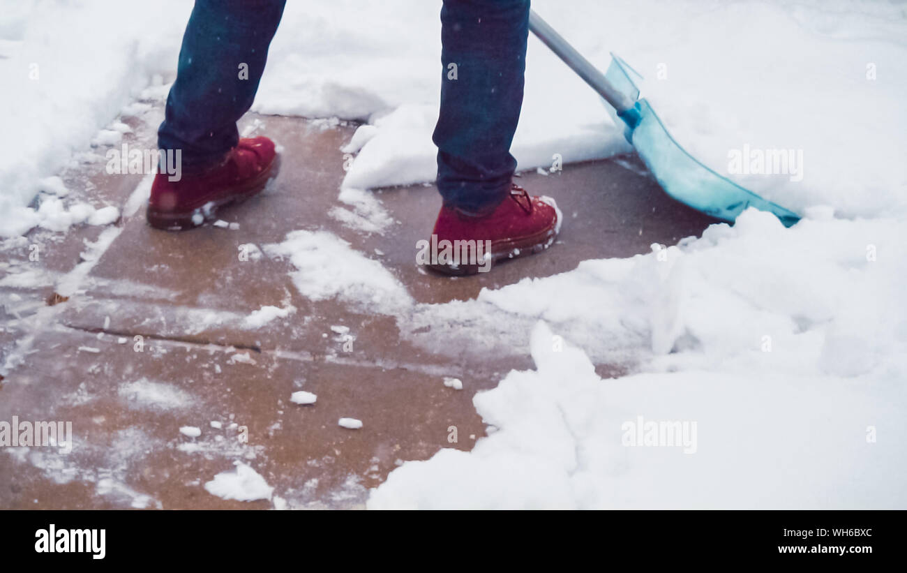 Young man shoveling snow from driveway Stock Photo Alamy