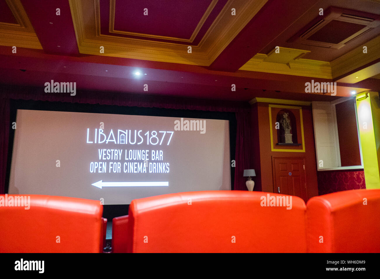 Libanus 1877,boutique,cinema,with,red,leather,seats,armchairs,with,cushions and blankets.Small,renovated,chapel,in,seaside,village,of,Borth,Wales,UK Stock Photo