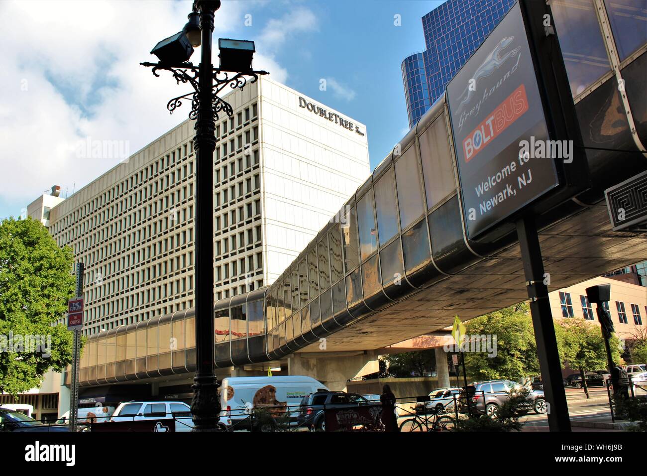View of the Double Tree Hilton Hotel in Newark, NJ, along with the pedestrian walkway above the busy street from Newark Penn station, opposite. Stock Photo