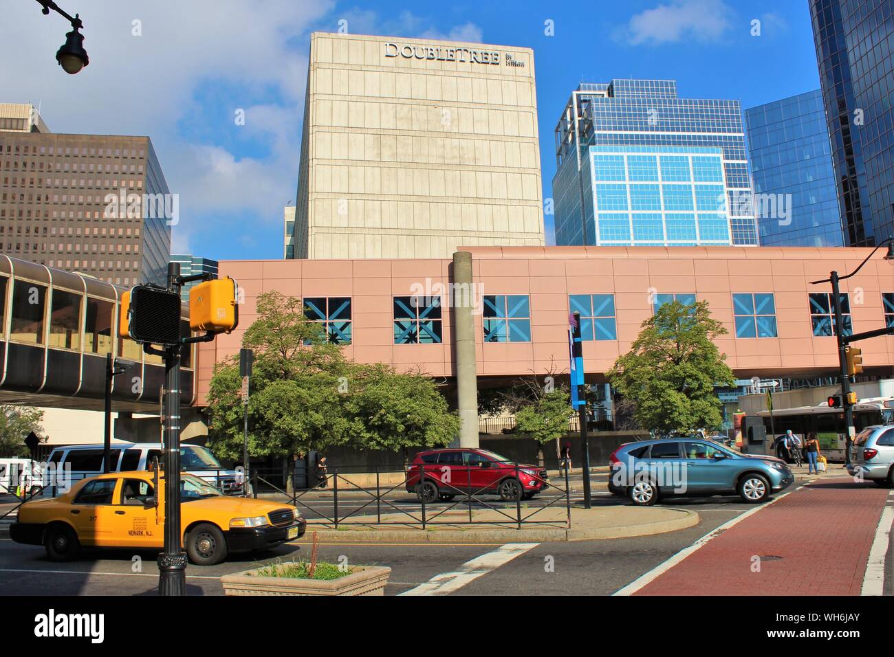 View across a busy highway, of the Double Tree Hilton Hotel in Newark, NJ, taken from outside the Newark Penn Station, opposite. Stock Photo