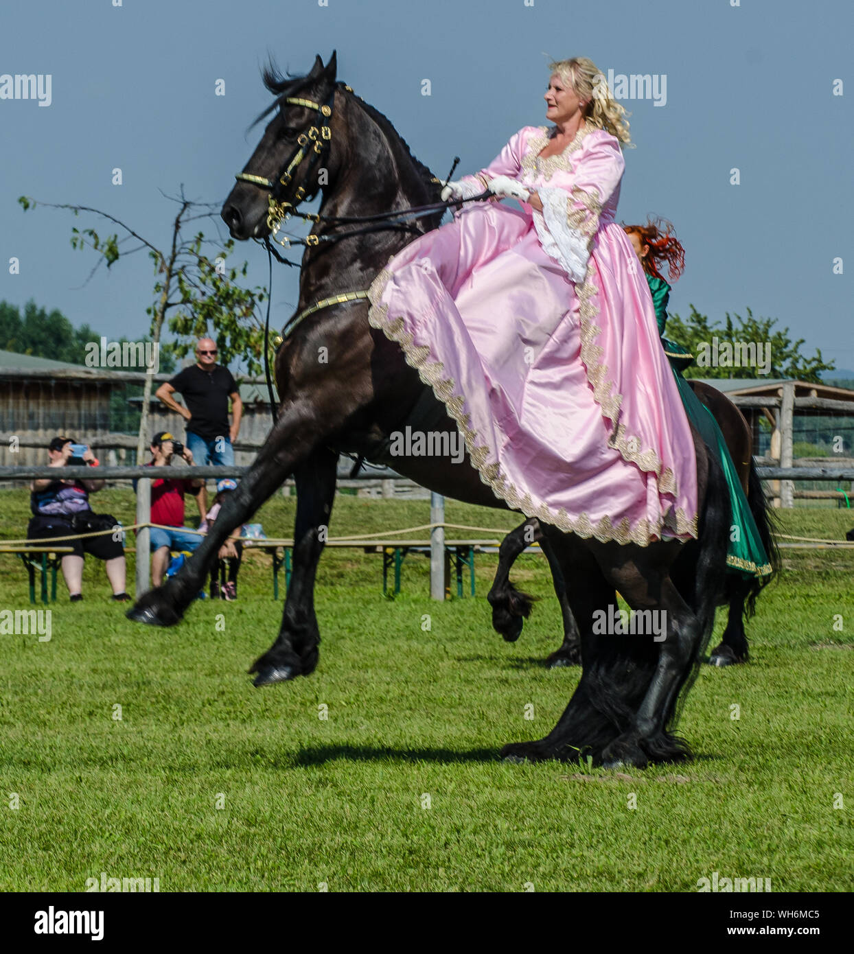 Schloss Hof Großes Pferdefest 2019 Great Equestrian Show at Schloss Hof Castle with two women riding on a side saddle Stock Photo