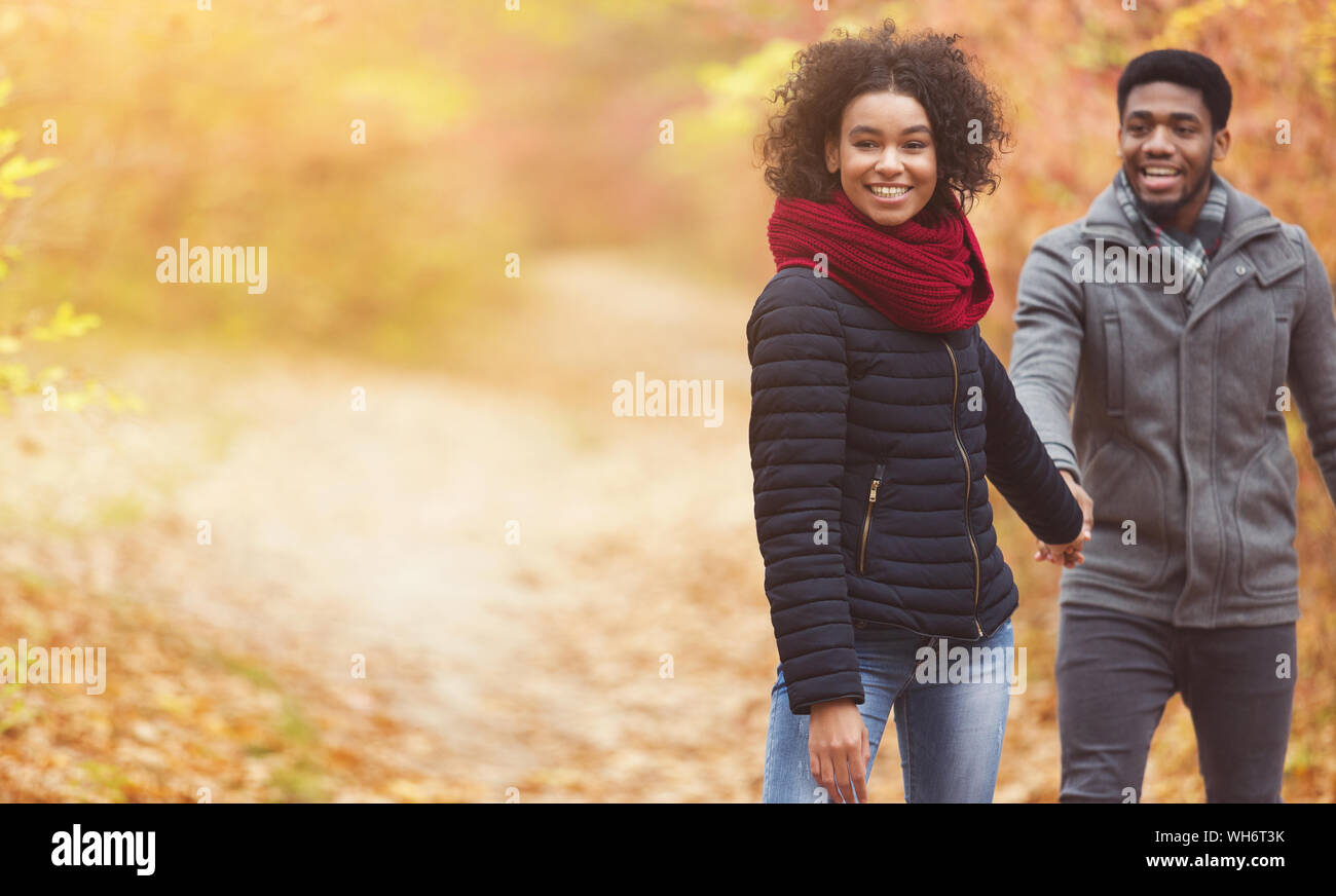 Follow me. Loving couple walking in autumn park Stock Photo