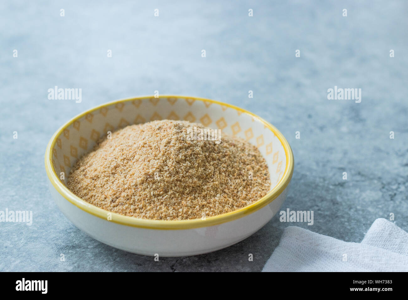 Bread Crumbs / Rusk Powder in Porcelain Bowl. Organic Food Stock Photo