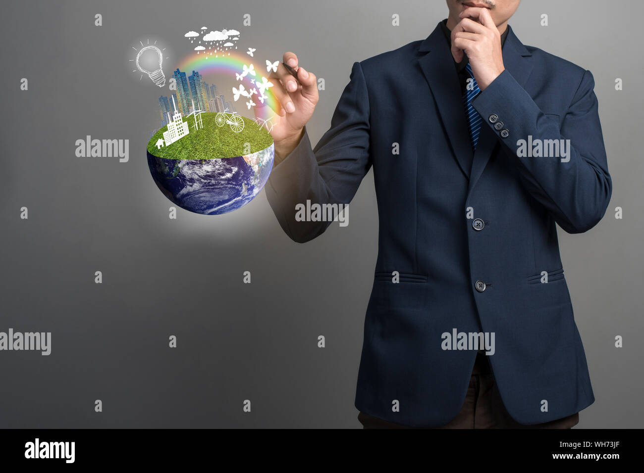Midsection Of Businessman Pointing At Illustrative Globe While Standing Against Gray Background Stock Photo