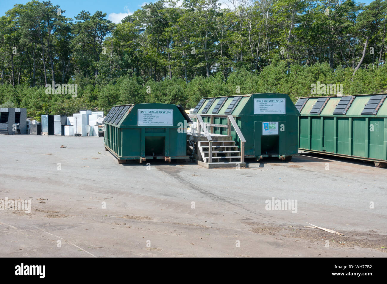 Single Stream recycling center containers & old refrigerators & appliances beyond at US landfill Bourne Integrated Solid Waste Management facility Stock Photo
