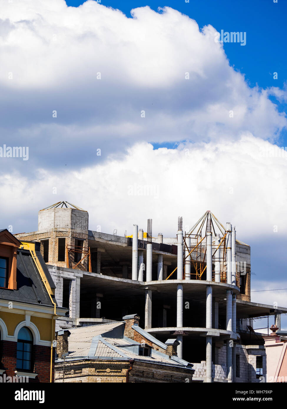 Low Angle View Of Incomplete Building Against Cloudy Sky Stock Photo
