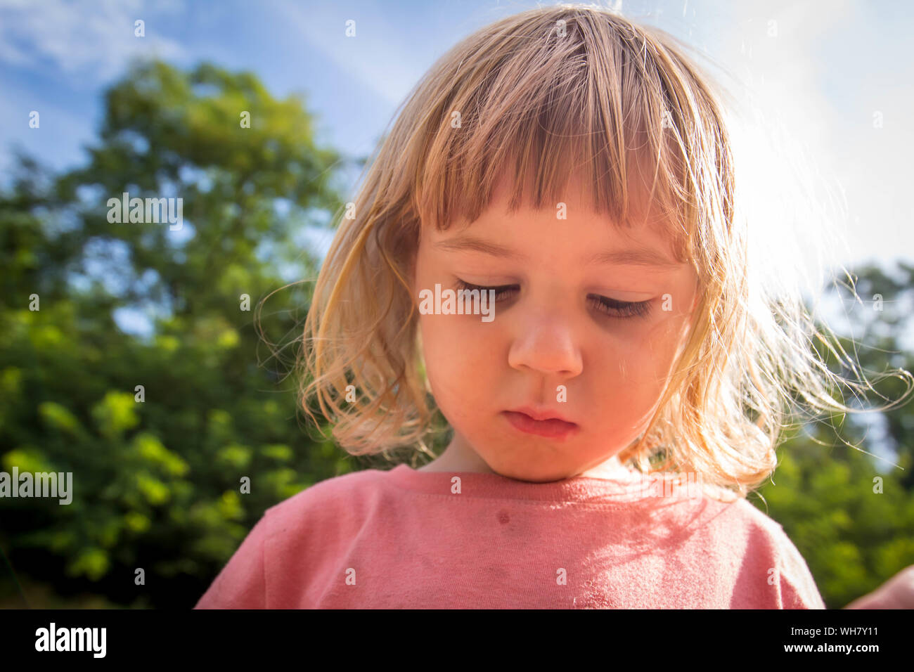 3 year old child blowing bubbles Stock Photo
