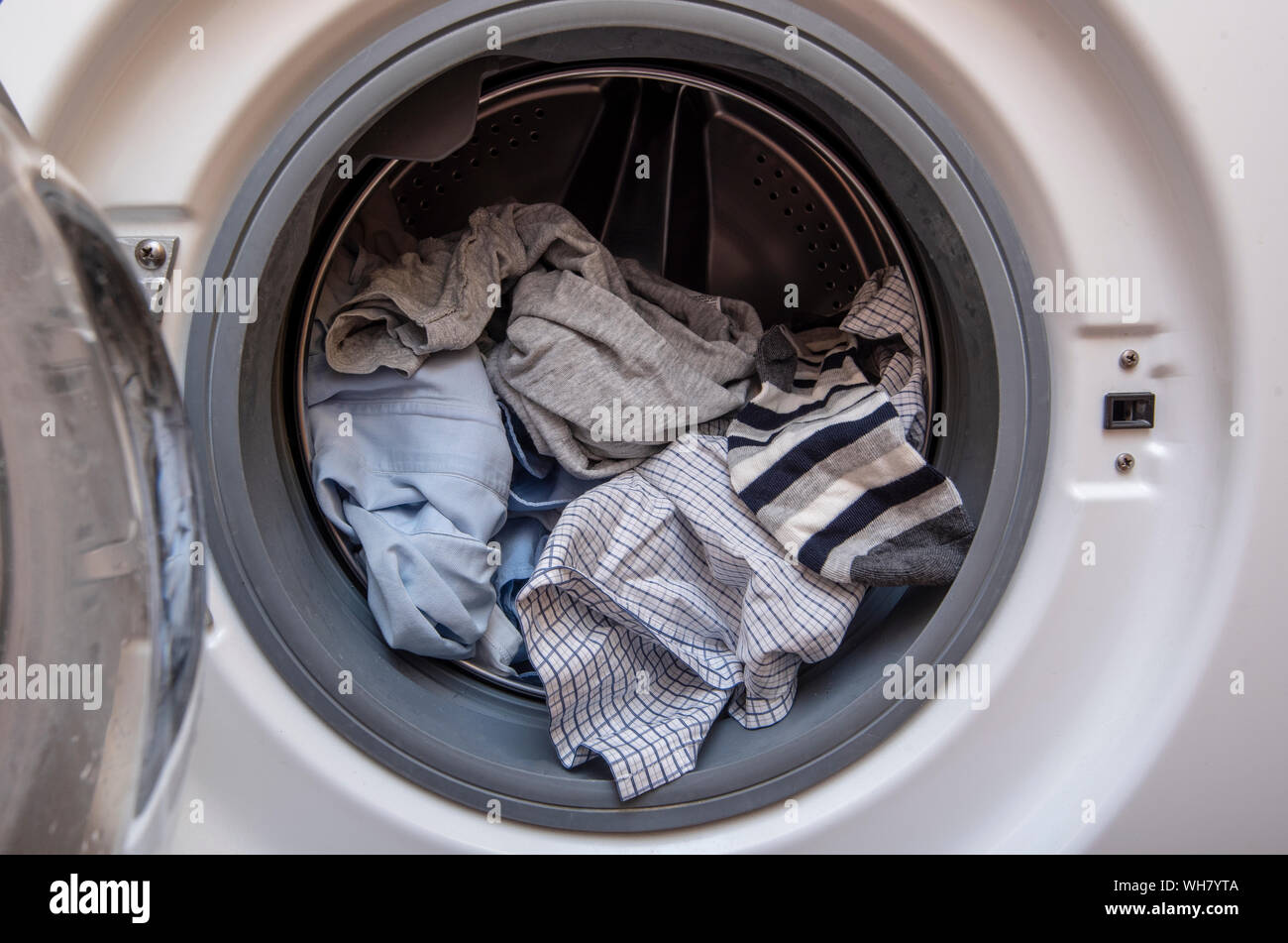 Washing Machine with opened Door and Dirty Clothes Before washing