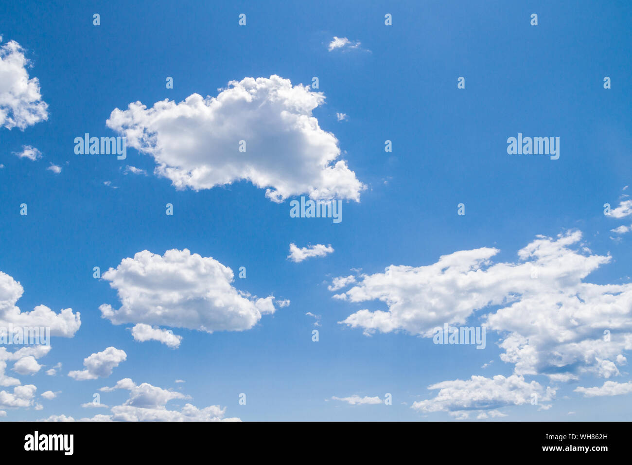 White fluffy clouds in the blue sky in summer Stock Photo - Alamy