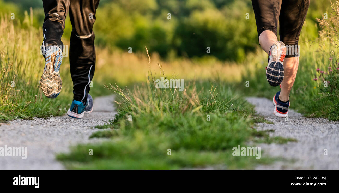 Legs of man and woman jogging Stock Photo