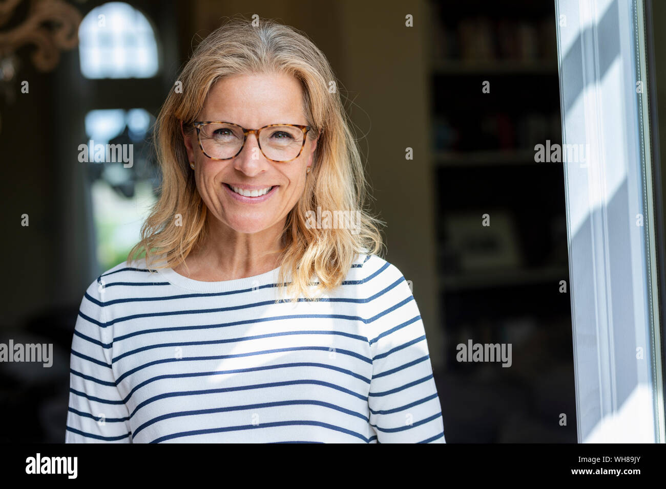 Portrait of smiling mature woman wearing glasses Stock Photo