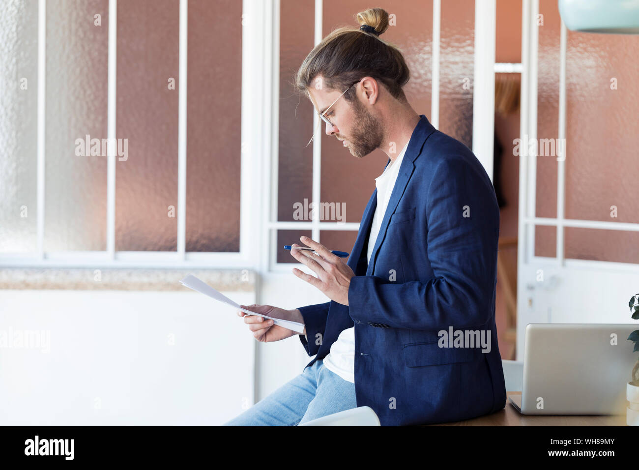 Businessman with papers in office Stock Photo