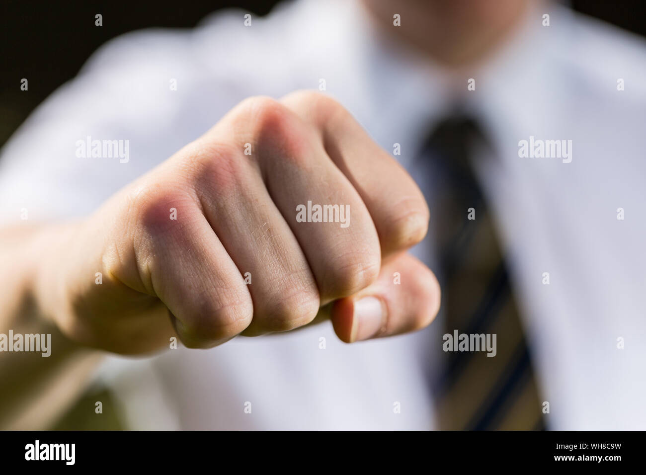 Close up of a school boy making a fist ready for a fight Stock Photo