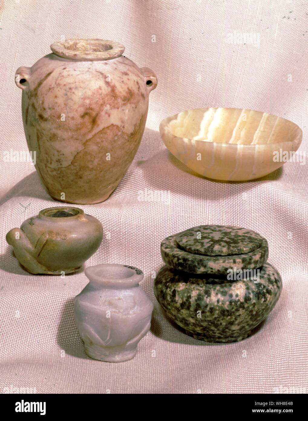 Five early dynastic pots two for cosmetics. Egypt under the Pharaohs by Barbara Sewell, page 137. Stock Photo