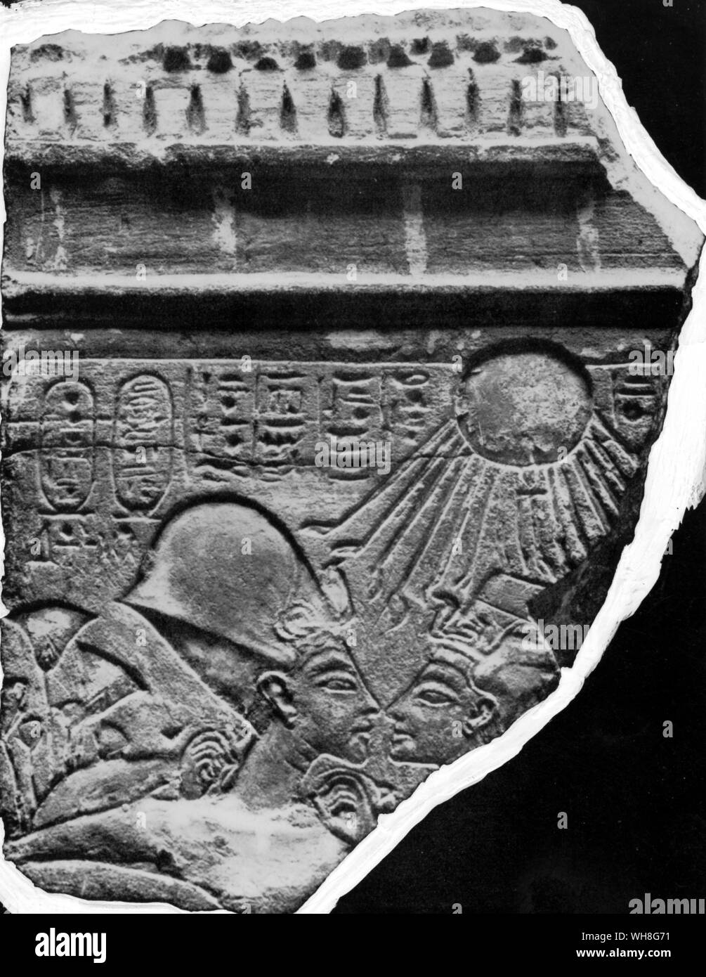 A fragment of the stele showing the Amarnan couple, symbol of creation by the Globe. Limestone. Tutankhamen by Christiane Desroches Noblecourt, page 164. Stock Photo