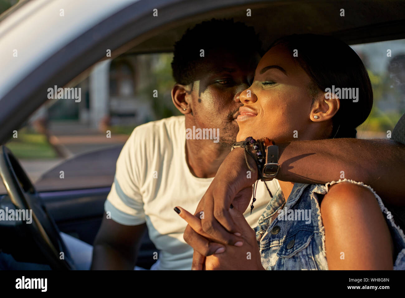 Young couple sitting car, kissing Stock Photo