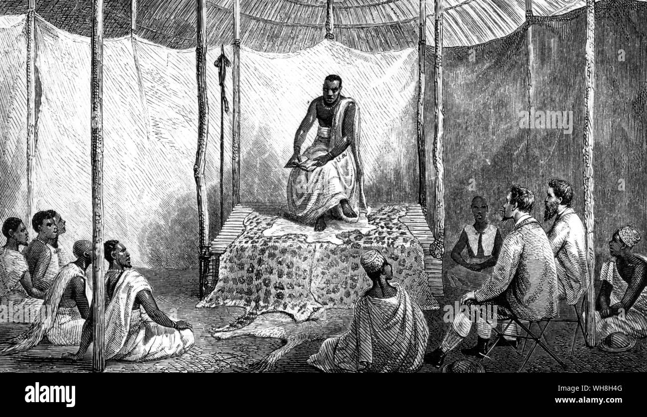 Speke and Grant give Kamrasi his first bible lesson. John Hanning Speke (1827-1864) was an officer in the British Indian army, who made three voyages of exploration to Africa. James Augustus Grant, (1827-1892) was a Scottish explorer of eastern equatorial Africa. In 1860, Grant joined Speke in the memorable expedition which solved the problem of the Nile sources. The African Adventure - A History of Africa's Explorers by Timothy Severin, page 233. . . . Stock Photo
