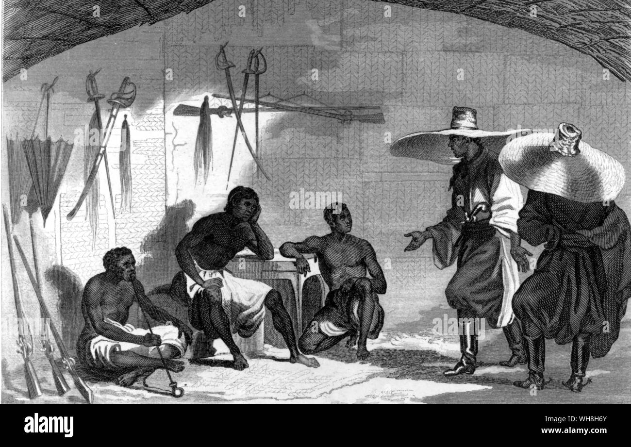 The Lander brothers (Richard and John), after landing at Badagry. John Lander (1807-1839) was the younger brother of Cornish explorer Richard Lemon Lander and accompanied him on his first expedition to western Africa. 'They came ashore from His Majesty's brig Clinker dressed in baggy Turkish trousers, bright loose-fitting gowns, and sporting a pair of enormous straw hats, each as large as an umbrella. The local girls found the sight so extraordinary that they turned aside to conceal their giggles.' The African Adventure - A History of Africa's Explorers by Timothy Severin, page 131. Stock Photo