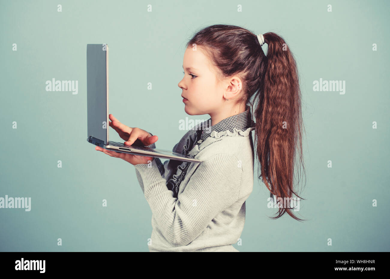 online courses private teaching. child development in digital age. Weblog in virtual world. online shopping blog. business digital marketing. happy small girl blogging on laptop. Happy student. Stock Photo