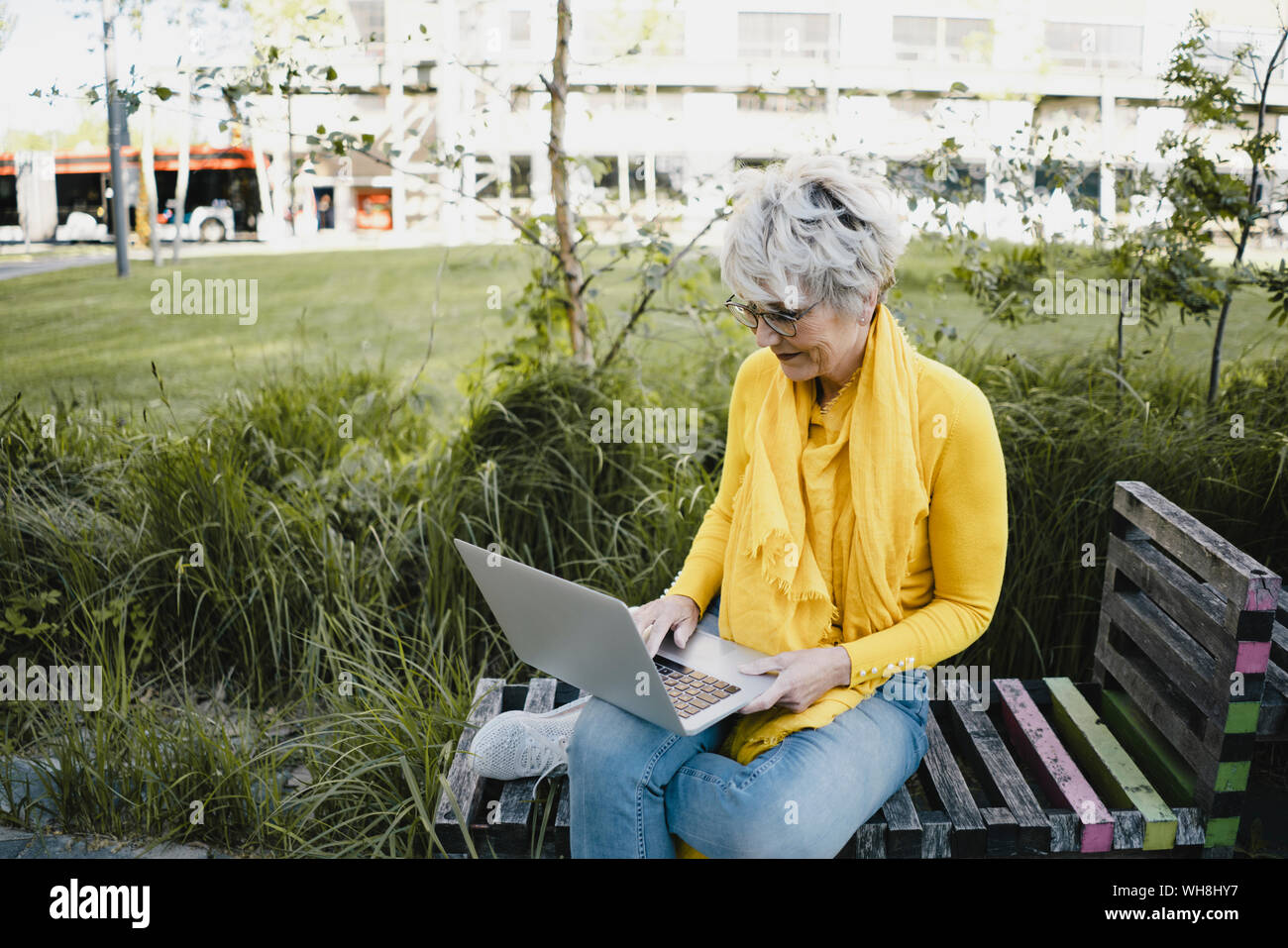 Mature woman sitting on bench hi-res stock photography and images - Alamy