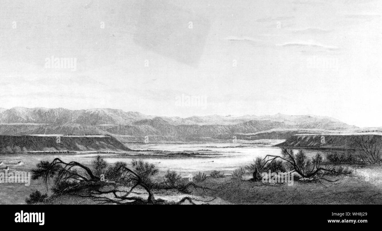 River Santa Cruz and distant view of the Andes. 'The curse of sterility is on the land, and the water flowing over a bed of pebbles, partakes of the same curse.' From Darwin and the Beagle by Alan Moorhead, page 145. Stock Photo