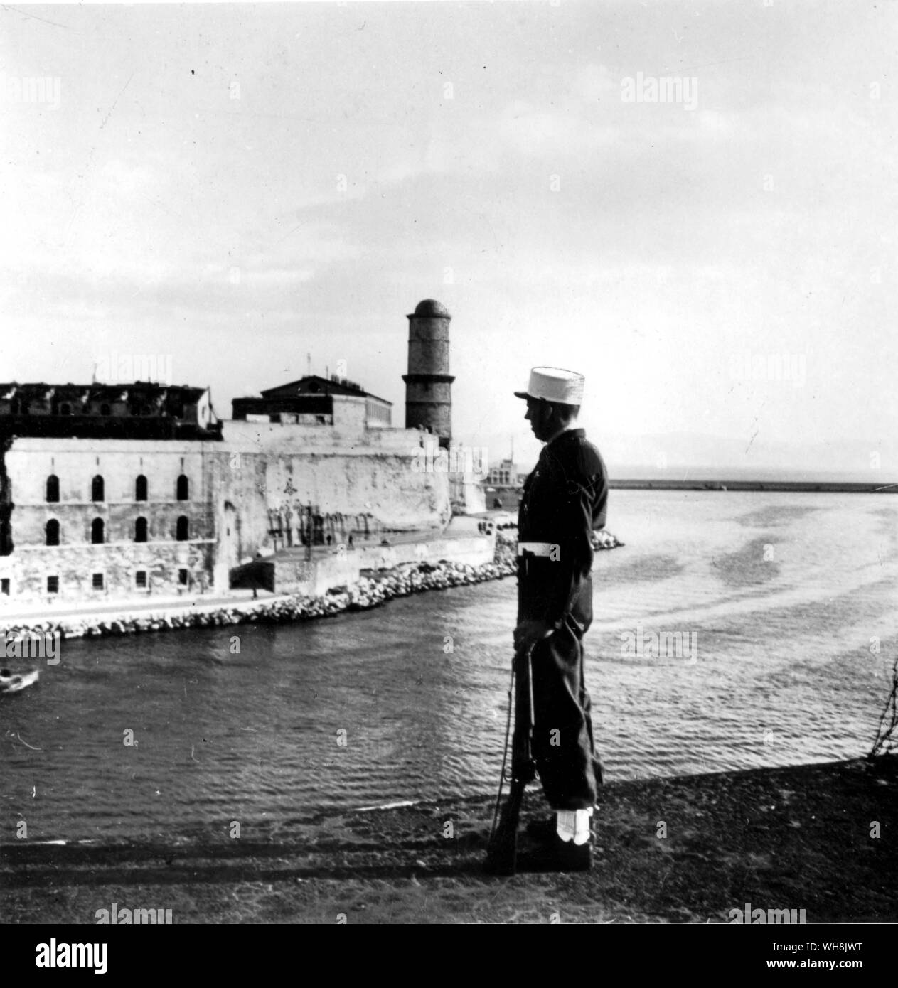 A legionnaire stands in front of the recruiting station at Fort St Jean, on the western side of the old port at Marseilles Stock Photo