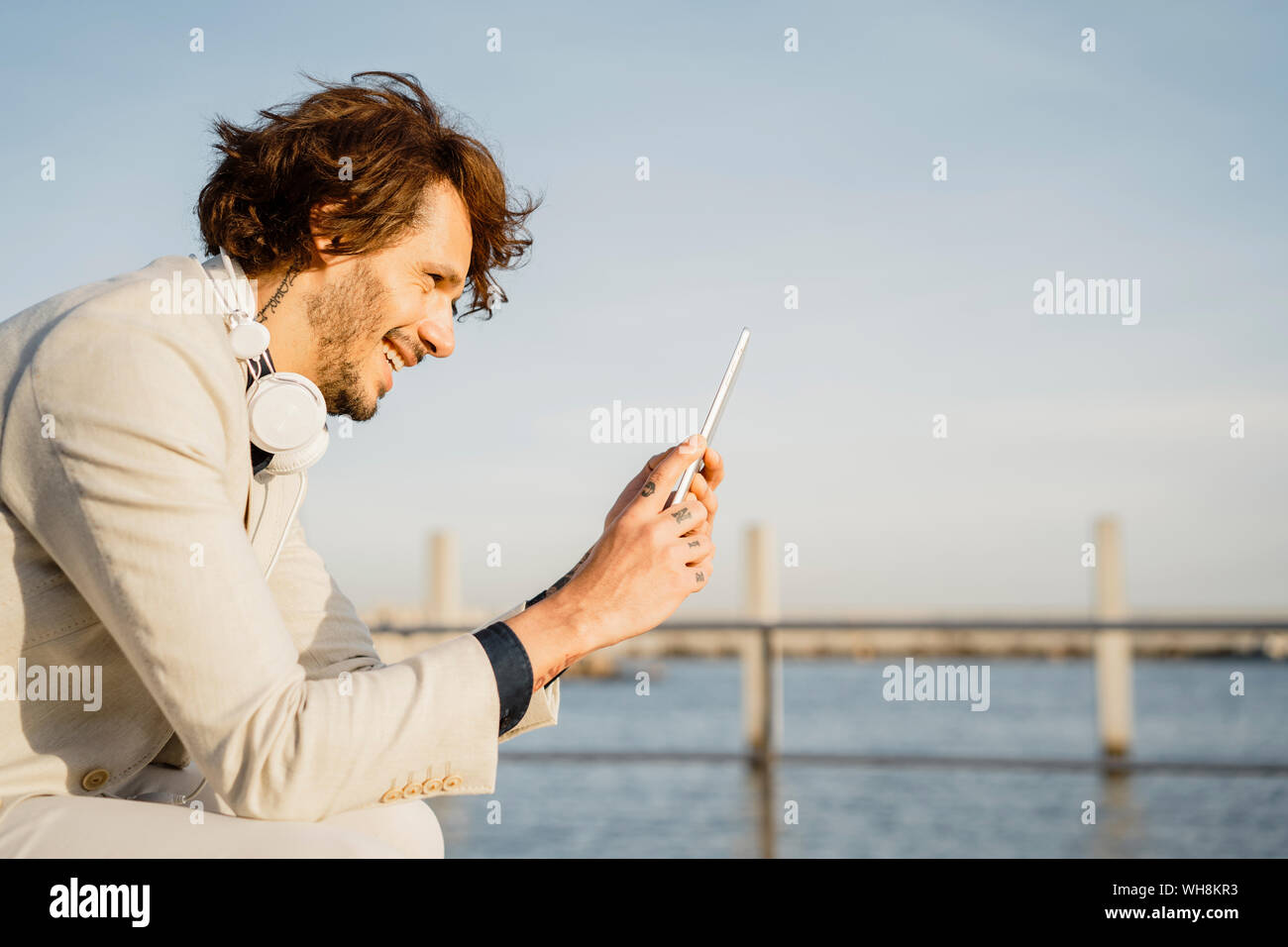 Laughing businessman using digital tablet outdoors Stock Photo