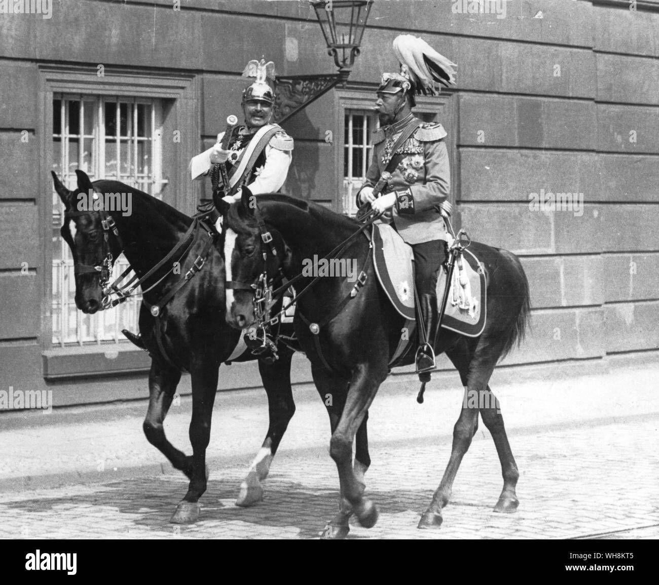 Let cousinly love prevail: Kaiser William II instructs King George in horsemanship whilst at the wedding of the Princess Potsdam Palace Stock Photo