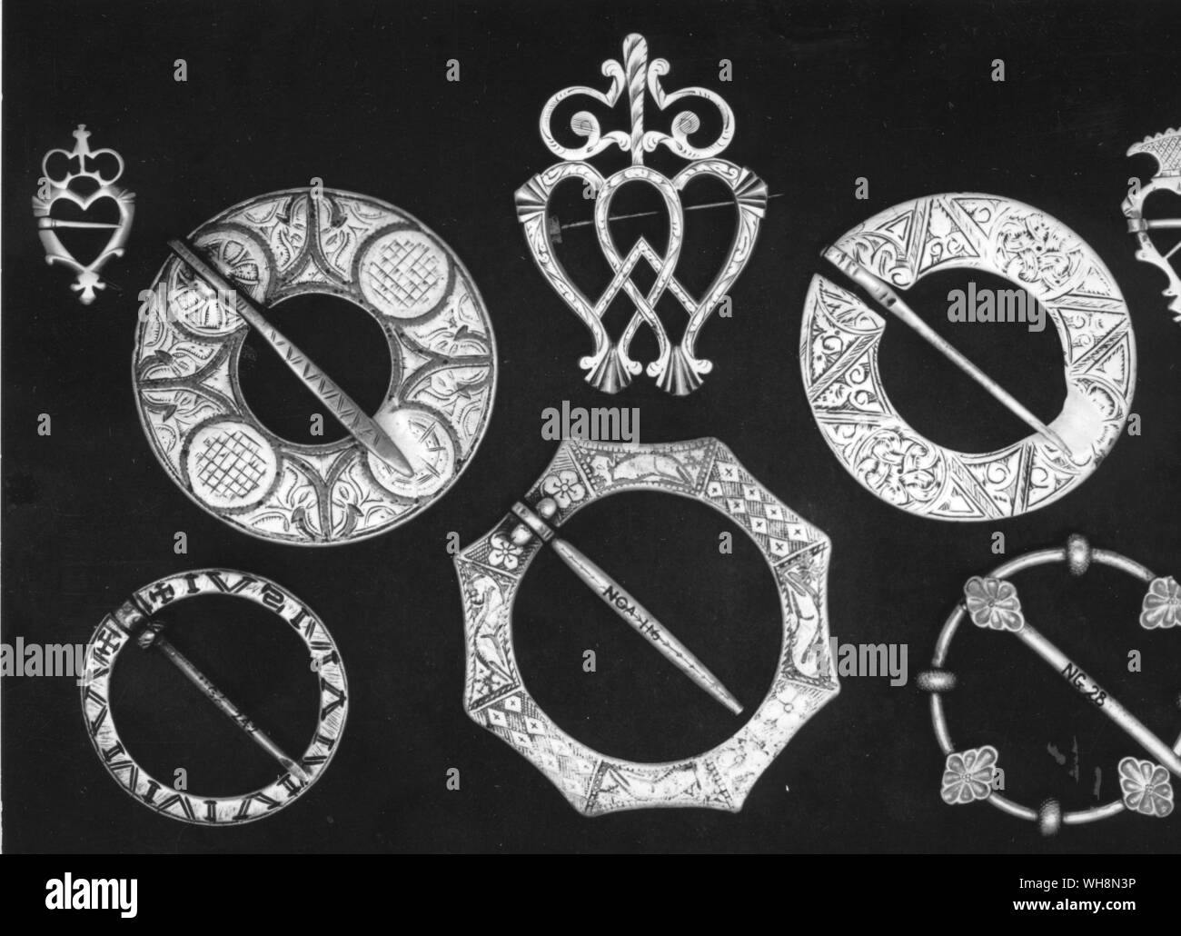 Scottish silver brooches heart shaped 18 and 19 century plaid fasteners (centre) 17 and 18 century talismanic etc (bottom) 14 and 15 century Stock Photo
