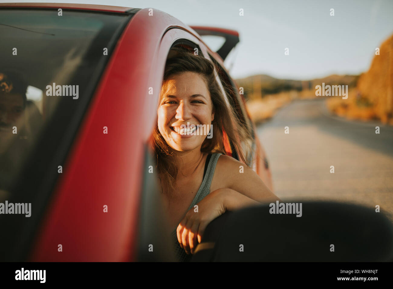 Woman on a road trip looking out of car window Stock Photo - Alamy